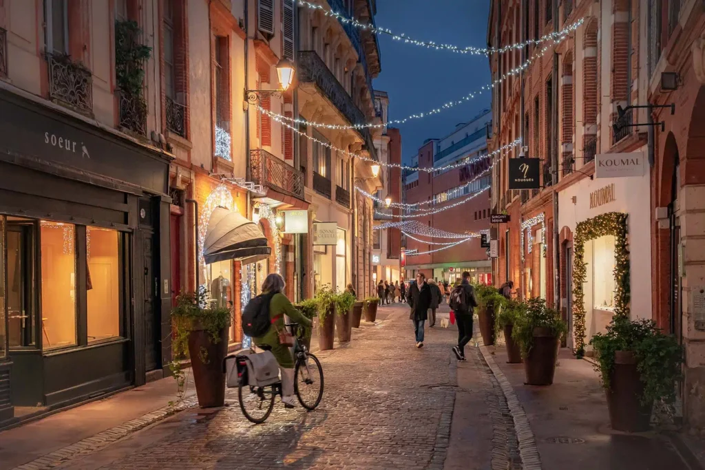 A street in Toulouse with pink-toned architecture and a calm atmosphere